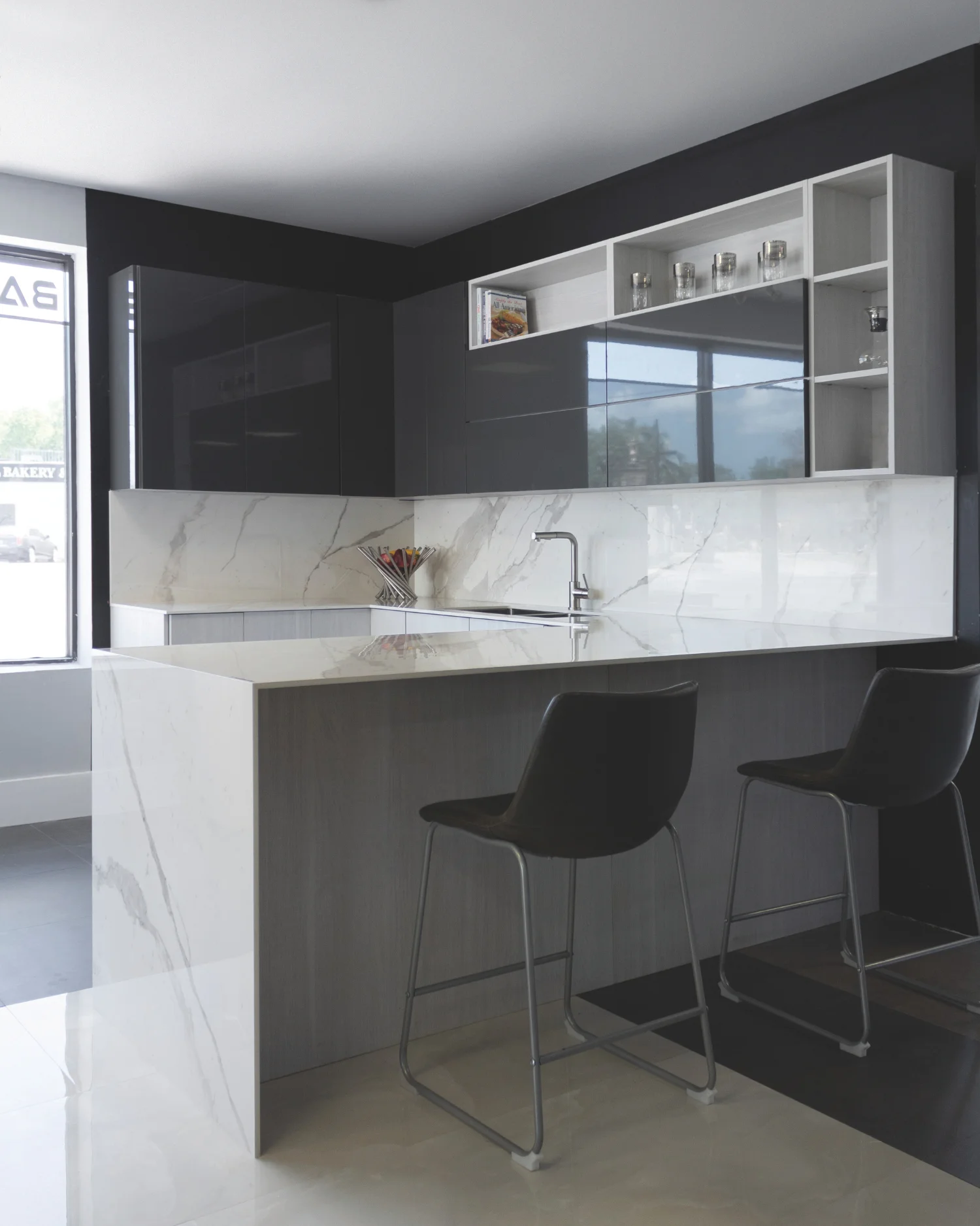 Kitchen featuring Laminam Bianco Statuario Venato Italian porcelain on countertops, waterfall island, and backsplash, showcasing white surfaces with elegant grey veining.